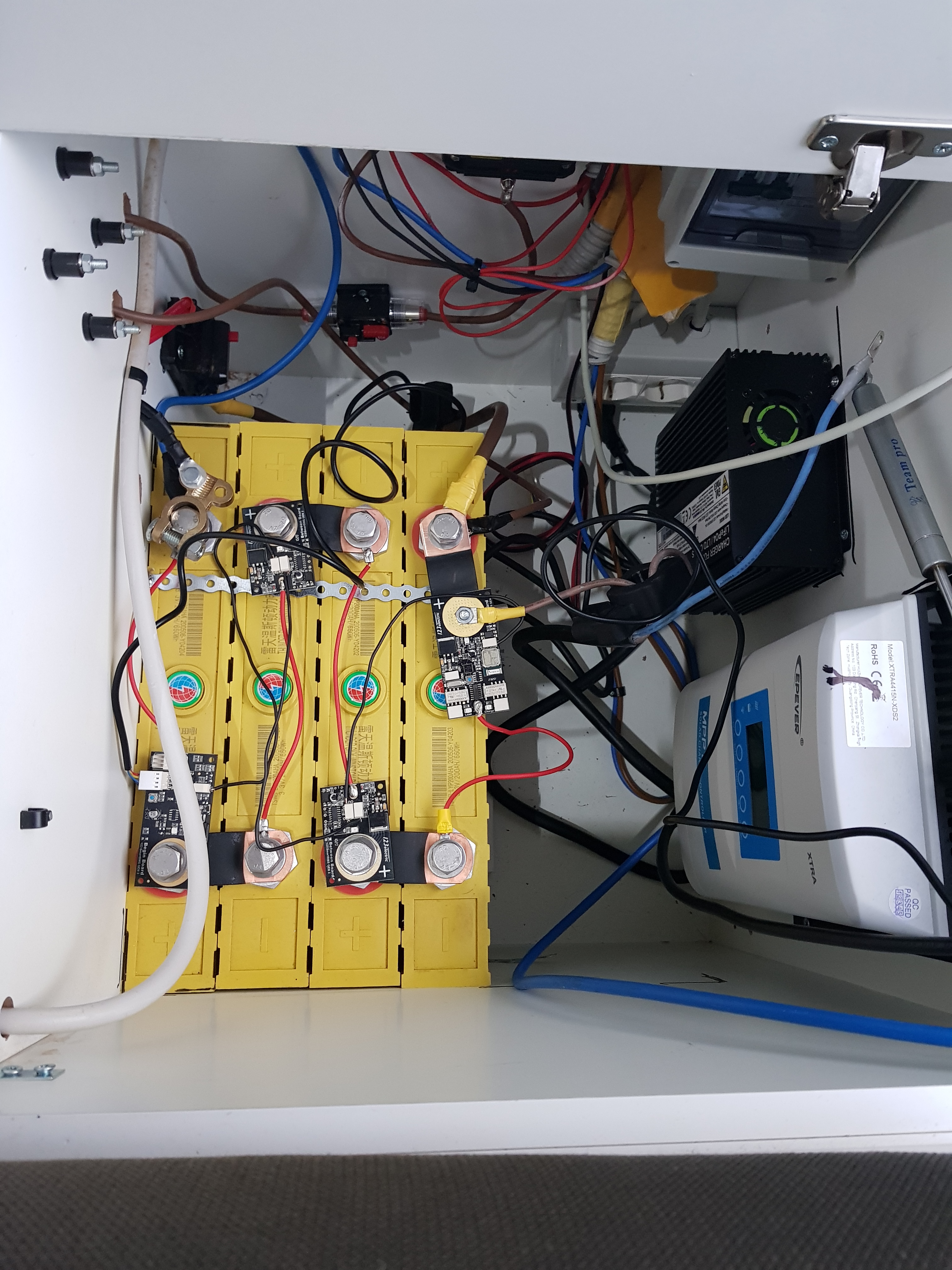200ah lithium battery. Detailed view of the solar power system inside the DIY Mercedes Sprinter camper van.