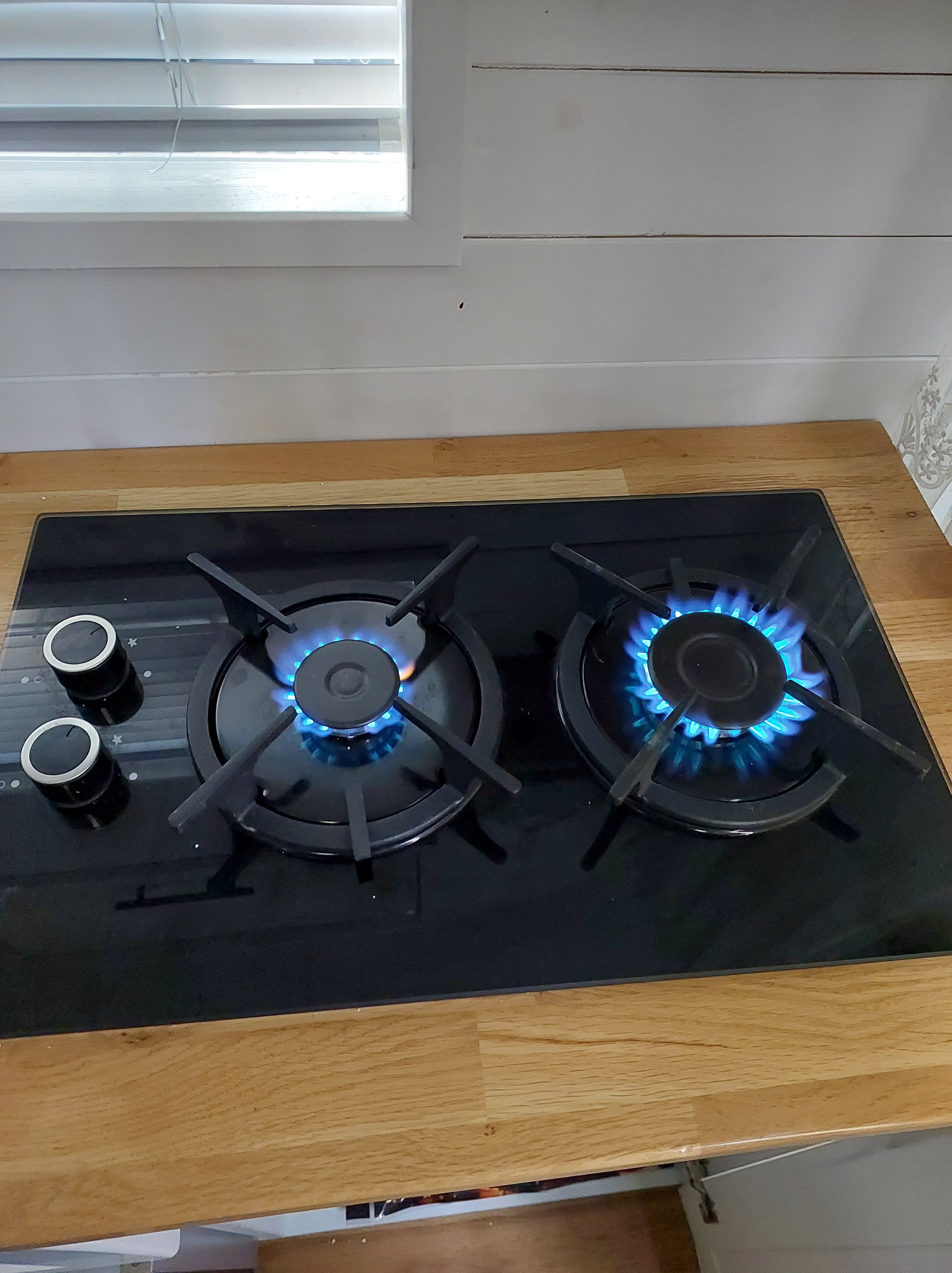 Cooking setup in the DIY Mercedes Sprinter camper van featuring a dual burner gas stove.
